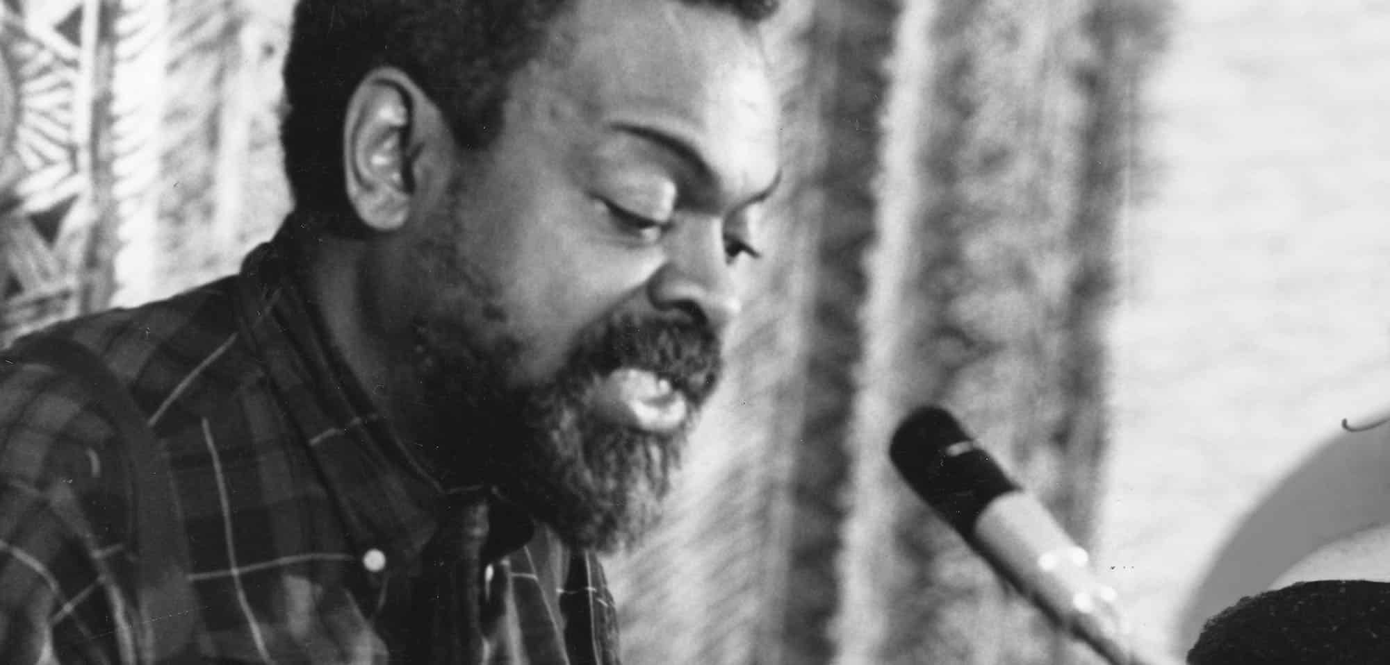 Amiri Baraka reading poetry at a podium